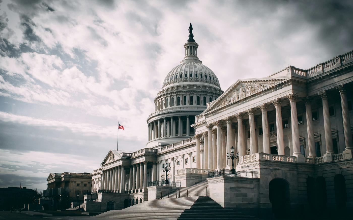 white concrete building under cloudy sky during daytime by Harold Mendoza courtesy of Unsplash.