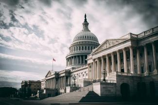 white concrete building under cloudy sky during daytime by Harold Mendoza courtesy of Unsplash.