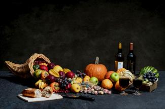 pumpkin and bottles on table by Brad Switzer courtesy of Unsplash.