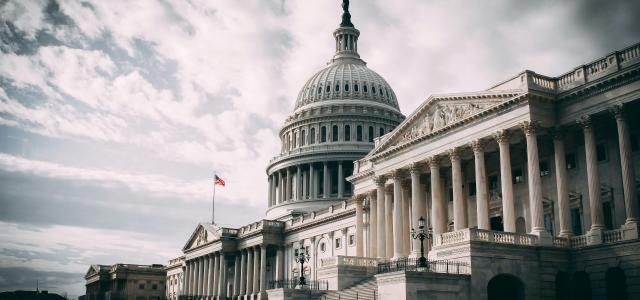 white concrete building under cloudy sky during daytime by Harold Mendoza courtesy of Unsplash.