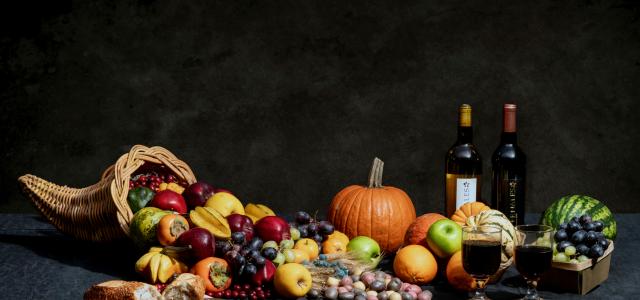 pumpkin and bottles on table by Brad Switzer courtesy of Unsplash.